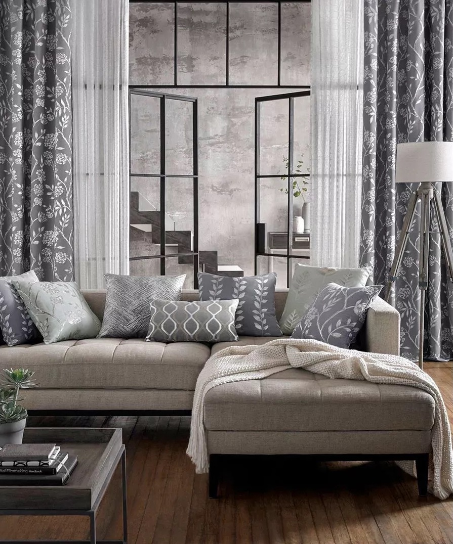 A room decorated with grey soft furnishings